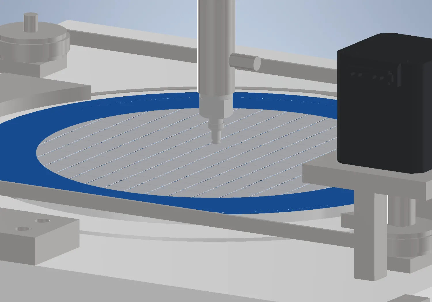 The test zone: a singulated wafer on expanded blue tape, the ejector rising from below and the collet descending from the head above.